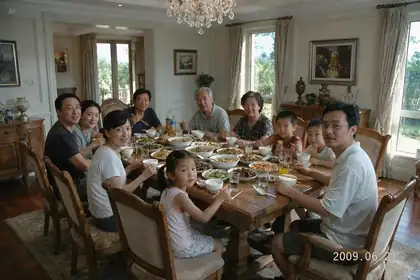 Official Seedream 5.0 Pro family dinner photo example with a large group seated together.